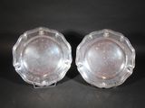 pair of silver plated dishes on stand on black background