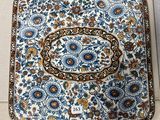 a blue and white plate with a floral design on it