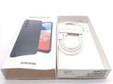 a box with a phone and a charger in it