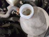 a close up of a water bottle with a hose attached to it