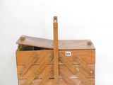 une petite boîte en bois munie d'une poignée en bois