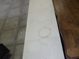 a long table with a wooden top in the middle of a room