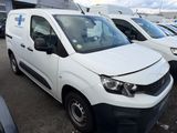 many white vans parked in a lot in a parking lot