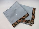 two pieces of blue cloth with orange and black flowers on them