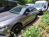 a silver car parked in a parking lot next to other cars