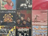 many different album covers on the wall of this room