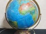 a small blue and green globe on a wooden stand