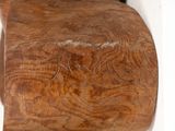 a close up of a wooden object on a white surface