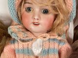two dolls that are sitting next to each other