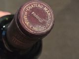a bottle of wine that is being held in someone ' s hand