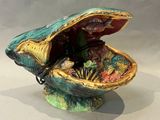 a small decorative shell with shells inside of it