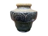 a vase that is sitting on a white surface