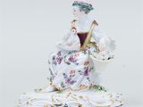 an image of a figurine of a woman with a basket of flowers