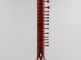 a close up of a musical instrument hanging from a ceiling