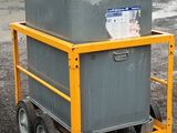 a small yellow cart with a gray container on it