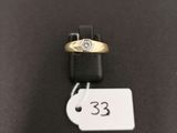 a close up of a gold ring with a diamond on it