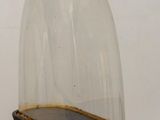 a glass dome with a black base on a wooden table