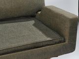 a couch that is sitting in a room with a lamp