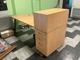 a desk with a file cabinet on it in a room