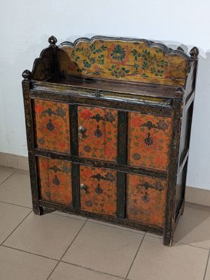 an old wooden cabinet with many drawers on it