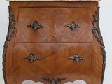 a small wooden table with a marble top on it