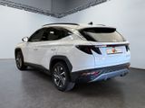 the rear end of a white toyota rav parked in a garage