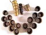 a lot of different types of brass fittings on a white surface