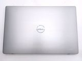 dell laptop computer sitting on a white surface with a dell logo on the screen