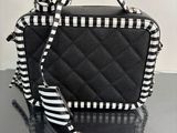 a black and white purse with a black and white ribbon
