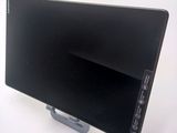a black computer monitor sitting on top of a white table