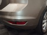 a car that has been painted silver in a garage
