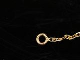 a close up of a gold chain with a lock on a black background