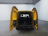 a yellow van with its doors open in a large room
