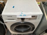 a washing machine that is sitting on top of a counter