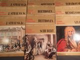 six books on a table with a picture of a man in a red coat