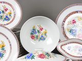 many plates and bowls that are sitting on a table