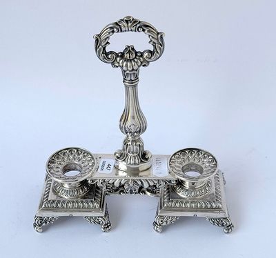 a silver plate with a candle holder on it