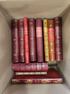 many books in the box on the shelf