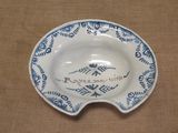 a blue and white plate with a name on it