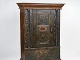an old wooden cabinet with ornate designs on the doors
