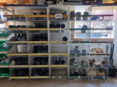 many shelves with pots and pans on them in a store