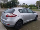 a silver car that is parked on the side of the road