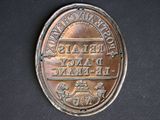 a metal plaque with a picture of a horse and carriage on it