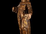 an old wooden statue of a man holding a dog on a wooden base