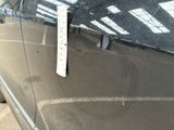 a sticker on the hood of a car that is parked on the side of the road