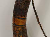 a long horn with a rope hanging from it ' s end