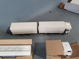 three trucks that are sitting on the floor next to each other