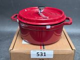 the large red pot is sitting on top of a cardboard box