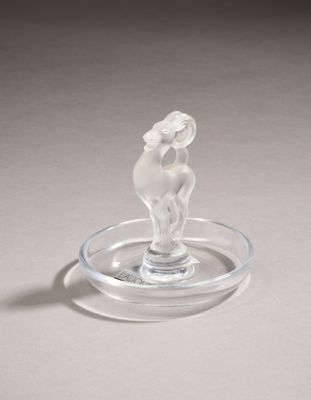 a glass figurine of a horse on a glass plate