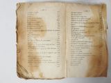 an old book with a list of numbers on it sitting on top of a table